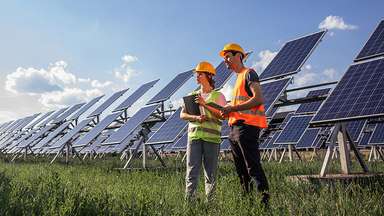 Engineers checking solar power farm